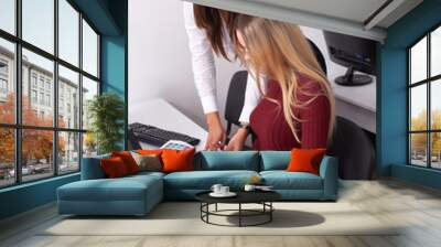 Two female colleagues in office working together. Wall mural