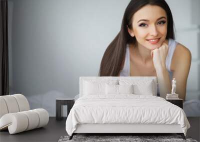 Young Beautiful Woman Lying on Bed Wall mural