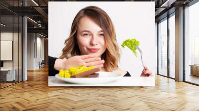 Young woman holding green broccoli, healthy way to lose weight Wall mural