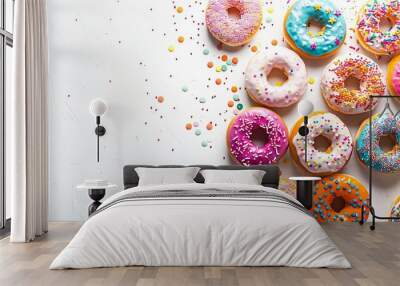 A vibrant assortment of colorful glazed donuts with sprinkles, arranged on a white background with ample copy space for a playful, inviting look Wall mural