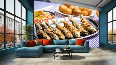 Grilled sardines with salad, bread and potato Wall mural