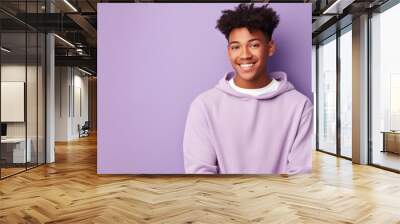 Happy, teen boy and portrait of a student smiling, high school and education concept with copy-space. Confident, African American male posing against a purple background in studio Wall mural