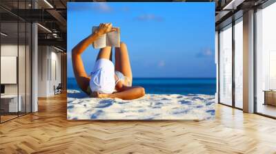 Young women is resting on the coral beach Wall mural