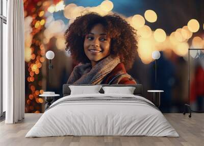 Black african american dark-skinned girl or young woman walking through a Christmas fair decorated market with festive lights in the evening. Holidays and celebration concept Wall mural