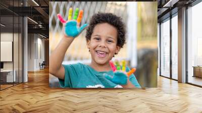 beautiful black happy boy with painted hands Wall mural