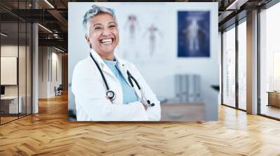 Happy, portrait and elderly woman doctor proud in hospital, excited and laugh for healthcare innovation. Face, elderly and female health expert smile for medical, mission or ready to help at clinic Wall mural