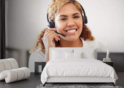 Happy, smiling and friendly call center agent wearing headset while working in an office. Portrait of confident businesswoman consulting and operating helpdesk for customer sales and service support Wall mural