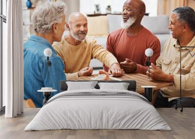 Senior men, friends and dominoes in board games on wooden table for activity, social bonding or gathering. Elderly group of domino players having fun playing and enjoying entertainment at home Wall mural