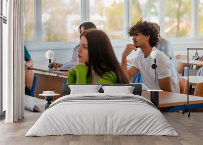 In the classroom group of college students listening to a lecturer and writing in notebooks. Wall mural