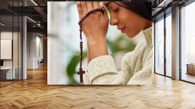 Praying, hands and Indian woman with a rosary in her home for worship, praise and gratitude to God. Jesus, pray and female with crucifix and prayer for hope, trust and Christian, faith or guidance Wall mural