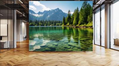 serene green lake nestled in the heart of towering mountains, under a clear, sunny sky Wall mural