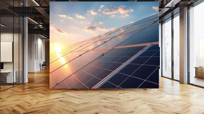 Solar panels gleam in the sunlight against a sunset sky Wall mural