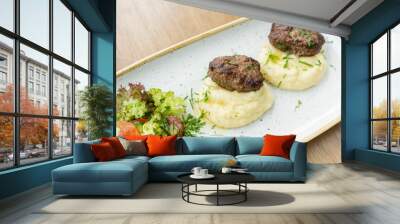 Delicious juicy meat cutlets, mashed potatoes sprinkled with greens and fresh healthy salad of tomatoes and lettuce leaves. Wall mural