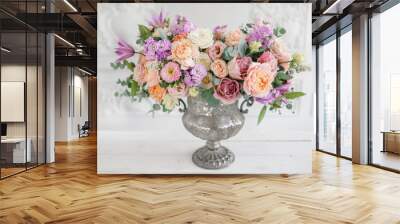 Gorgeous bouquet of different flowers. floral arrangement in vintage metal vase. table setting. lilac and peach color Wall mural