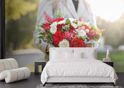 lovely woman holding a beautiful autumn wedding bouquet. flower arrangement with white and red garde Wall mural