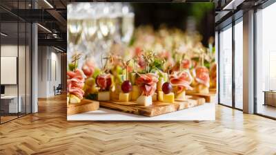 the buffet at the reception. glasses of wine and champagne. assortment of canapes on wooden board. b Wall mural