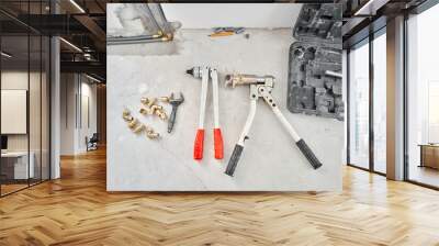 Tools for Work As A Plumber. Connection heating pipes to white Radiator in a new apartment under construction. water heating radiator on the white wall indoors Wall mural