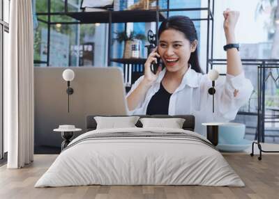 Asian woman in white shirt using laptop. Wall mural