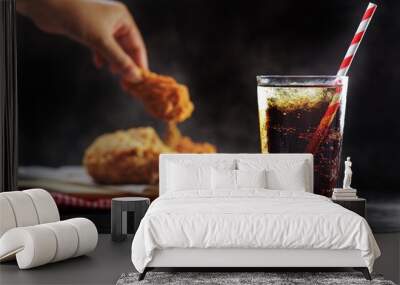 Close up A glass of fizzy soft drink over chicken wings dish background Wall mural