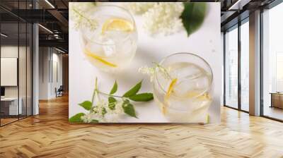 A delicious cold summer drink made of elderflowers with ice on a light background Wall mural