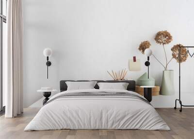 Empty desk, white table with minimal vase with a decorative dried branches against white wall. Wall mural