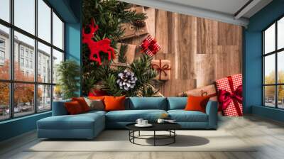 Gifts under christmas tree on wooden floor. Top view with copy Wall mural