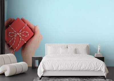 Hands giving a gift box. Wall mural