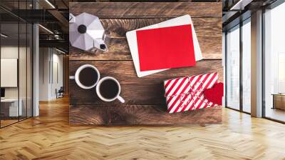 Valentine's day card, coffee maker and two cups of coffee, Holiday gift, present with felt heart, blank notebook opened with red greeting card on wooden table. View from above. Flat lay. Wall mural