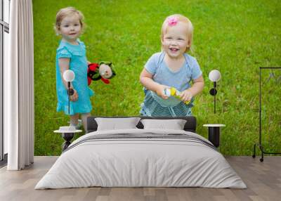 Little girls on nature playing toy Wall mural