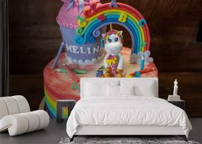 Closeup shot of a colorful rainbow unicorn back-to-school cake Wall mural