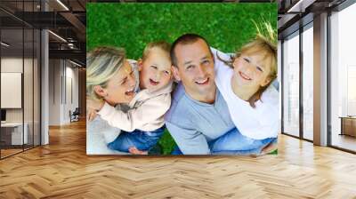 Happy family on a background of grass top view Wall mural