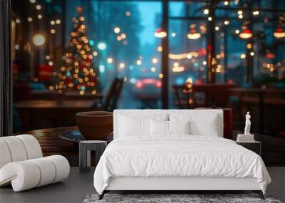 A cup of coffee on a table in a cozy cafe with a Christmas tree and lights in the background. Wall mural