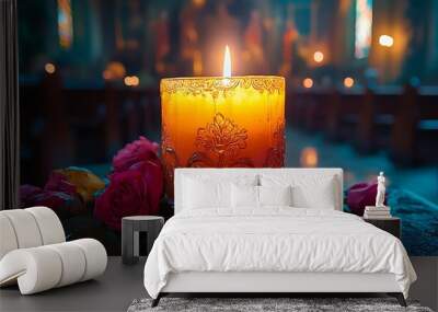 A lit candle with roses in a church. Wall mural