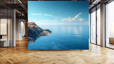 A red and white lighthouse stands tall on a rocky cliff overlooking a calm blue sea with a clear sky and fluffy white clouds. Wall mural