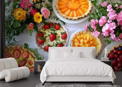 A table is decorated with various fruit pies and fresh flowers for a summer celebration. Wall mural