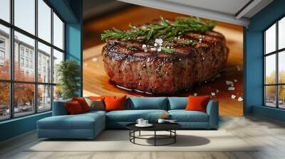 Close-up of a perfectly grilled steak with rosemary and sea salt on a wooden cutting board. Wall mural