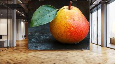 Close-up of a red and yellow pear with water droplets on a dark background. Wall mural