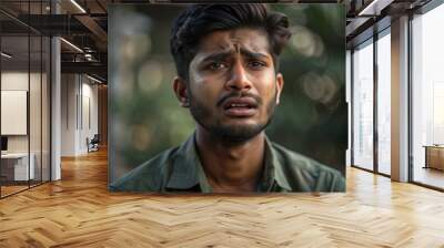 Sad Indian young man shedding tears, looking very upset,Indian young man with a sad expression, crying like a baby Wall mural