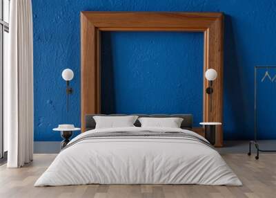 wooden portrait frame on blue wall Wall mural