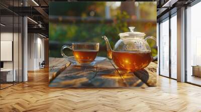 Black tea in glass cup and teapot on summer outdoor background. Copy space. Wall mural