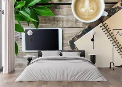 Modern workspace home office desk table with blank spiral notebook, digital tablet , cup of coffee and green plant leaves. Top view, copy space Wall mural