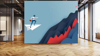 Business man on white paper leader airplane flying over obstacle to the red flag target on mountains .Successful and business concept. Wall mural