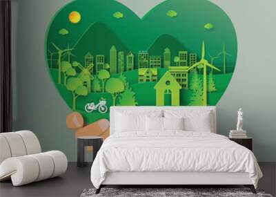 Hand holding green heart with urban forest and eco city abstract paper art background.Ecology and environment conservation with love nature concept.Vector illustration. Wall mural