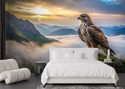 Majestic upland buzzard perched on a moss-covered rock, gazing intensely into the distance, against a backdrop of misty, rugged mountain landscape at dawn. Wall mural