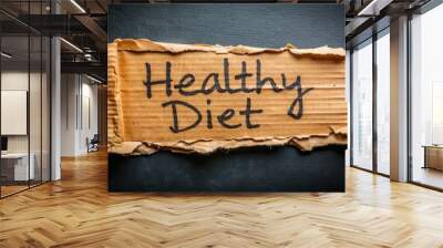 Ripped cardboard paper with a bold, handwritten healthy diet message on a dark black background, providing a unique and eye-catching symbol for a nutritious lifestyle choice. Wall mural