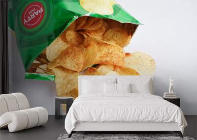 Bangkok, Thailand - May 15, 2022 Potato chips in open bag, delicious BBQ seasoning spicy for crips, thin slice deep fried snack fast food in open bag. Wall mural