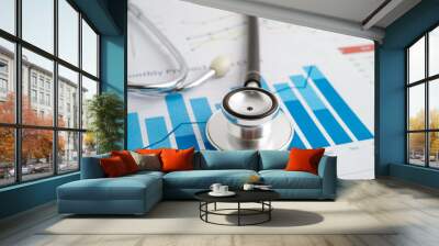 Stethoscope on chart or graph paper, Financial, account, statistics and business data medical health. Wall mural