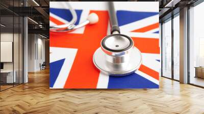 United Kingdom flag with black stethoscope, Business and finance concept. Wall mural