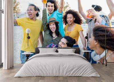 Friends having a beach party, young people having fun dancing and drinking on holiday, happy girls and boys at music festival Wall mural