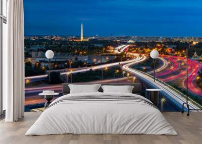 Washington D.C. cityscape at dusk with rush hour traffic trails on I-395 highway. Washington Monument, illuminated, dominates the skyline. Wall mural